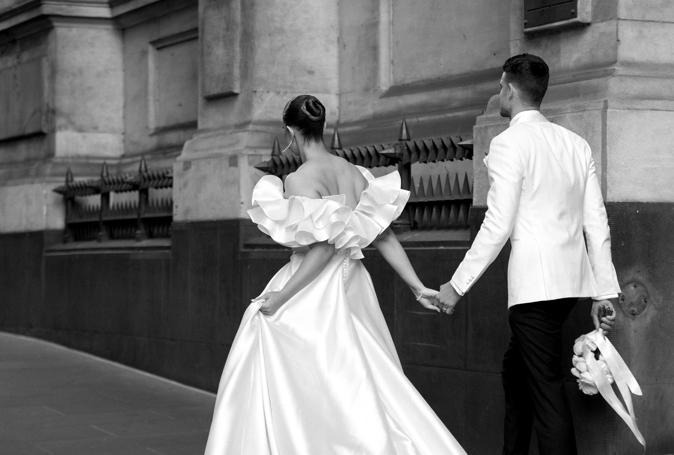 Happy couple strolling through the streets of Melbourne, beautifully captured by Art of Grace Photography, showcasing a romantic and timeless wedding moment in the heart of the city.